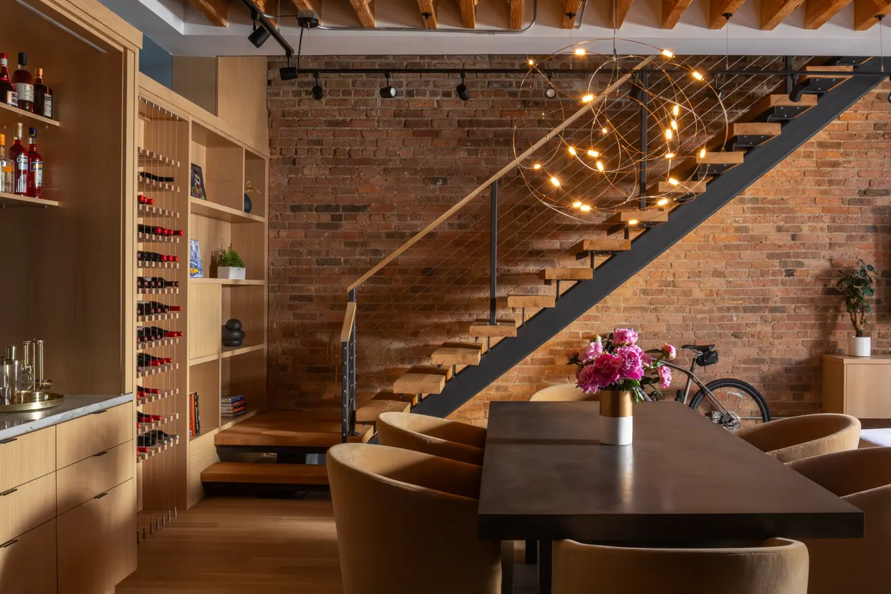 Dining area beside the floating stair and wine wall