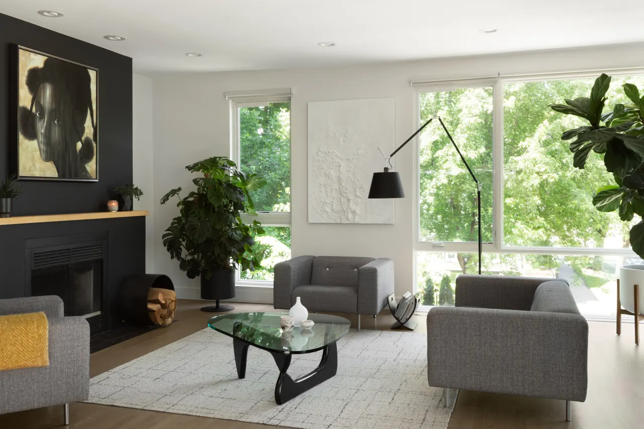 Living room with black fireplace wall and sculptural lighting