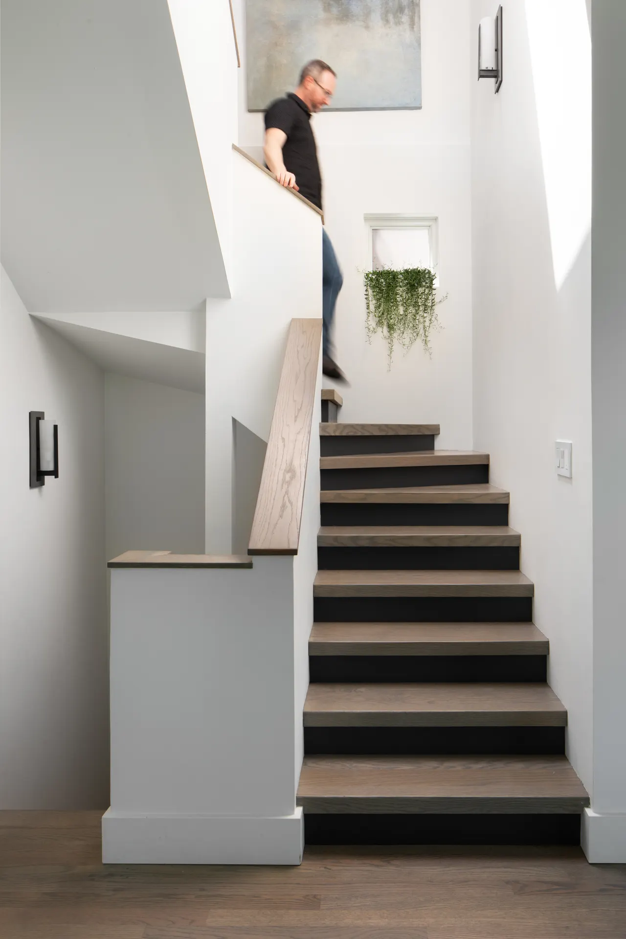 Staircase with wood treads and slim handrail