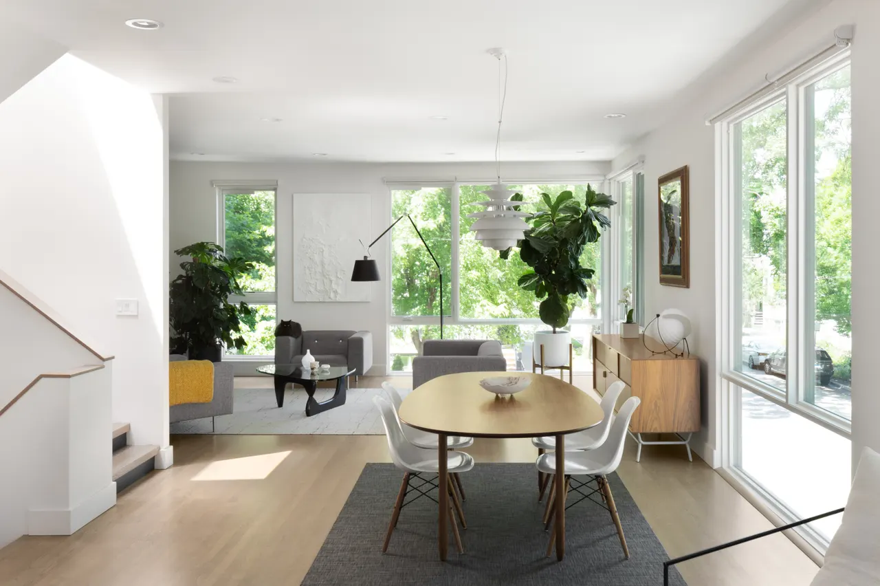 Living and dining room with large windows and oak floors