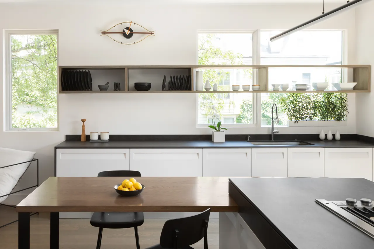 Kitchen with floating wood shelving and dark countertops