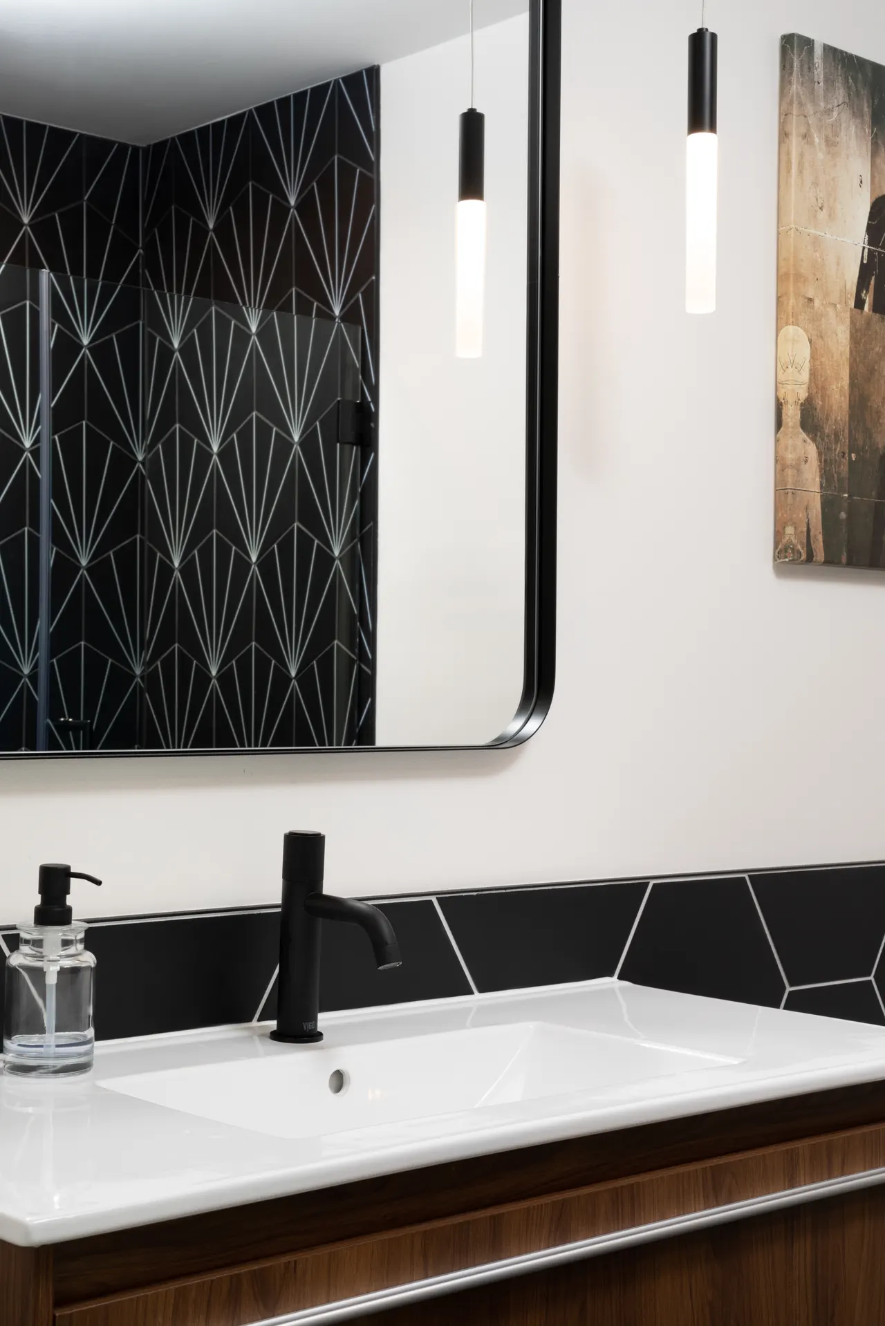 Bath detail: black fan tile and matte black fixtures