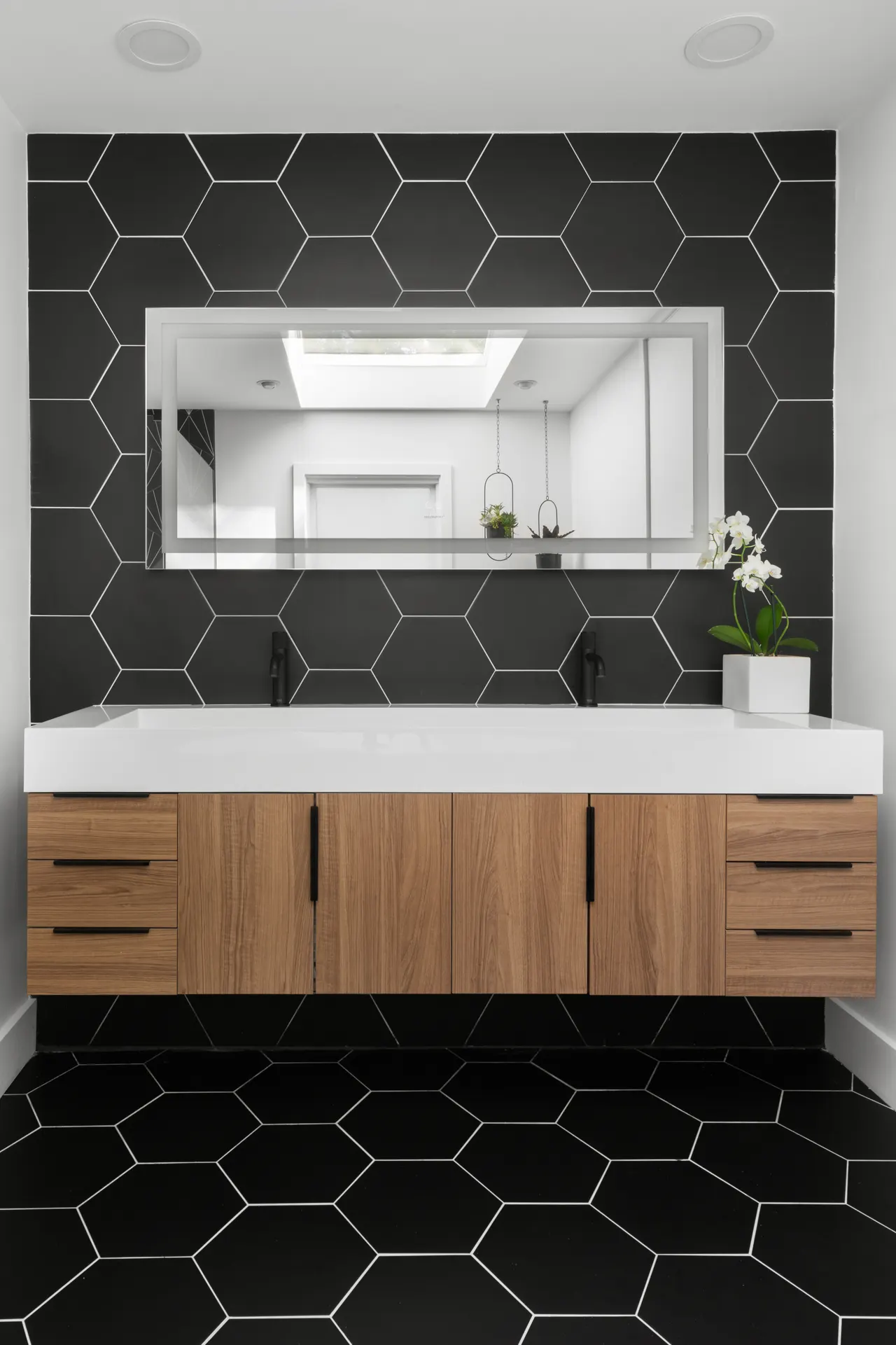 Double vanity in walnut with hexagon tile backsplash