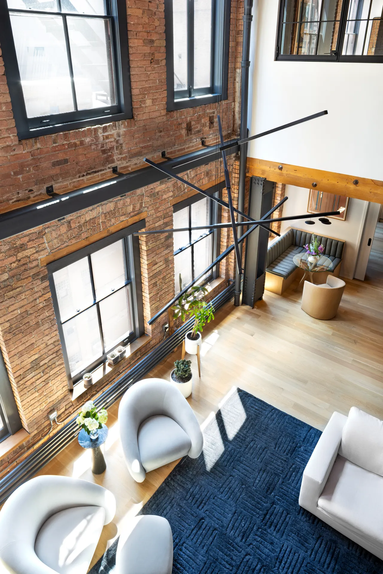 Living room seen from above, with tall factory windows